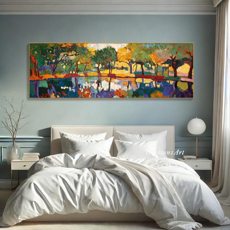 May include: A white bed with a white duvet cover and two white pillows. A colorful abstract painting of trees and a lake hangs above the bed on a light blue wall.