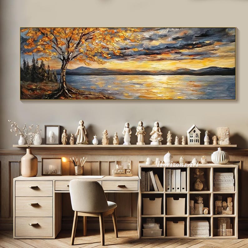 May include: A painting of a lake scene with a tree in the foreground and a sunset in the background. The painting is done in a palette of warm colors, including yellow, orange, and red. The painting is framed in a gold frame.
