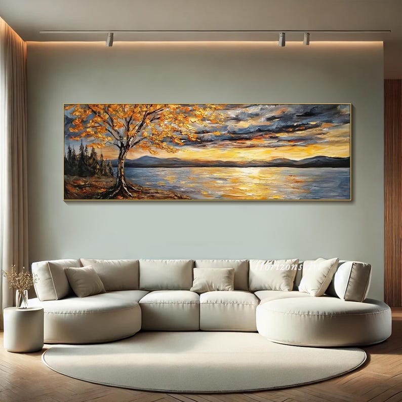 May include: A painting of a lake scene with a large tree in the foreground. The tree has yellow leaves and is silhouetted against a sunset sky. The lake is calm and reflects the colors of the sky.