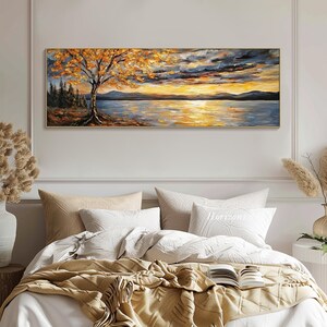 May include: A painting of a lake scene with a tree in the foreground and a sunset in the background. The sky is a mix of blue, gray, and orange. The water is a deep blue with reflections of the sunset. The tree is a golden yellow with a few green leaves.
