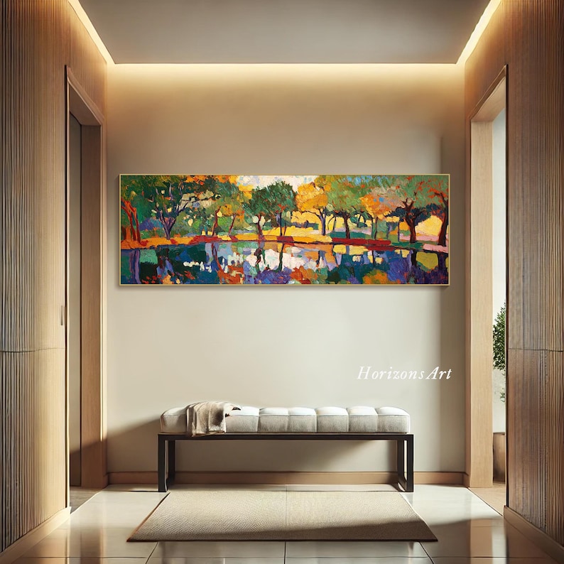 May include: A colorful abstract painting of trees reflected in a still body of water. The painting is framed and hanging on a wall in a modern hallway.