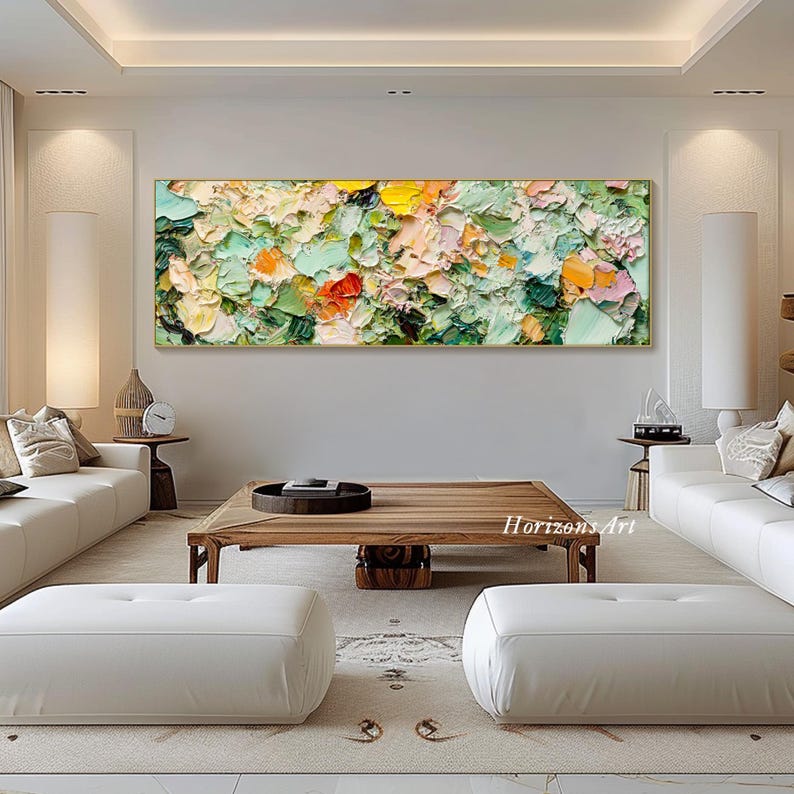 May include: Abstract painting with a textured, impasto style. The painting features a variety of colors, including green, yellow, orange, and pink. The painting is framed in a gold frame and is hanging on a white wall.
