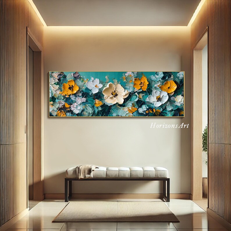 May include: A large abstract painting of yellow and white flowers on a teal background. The painting is framed and hanging on a wall in a hallway.