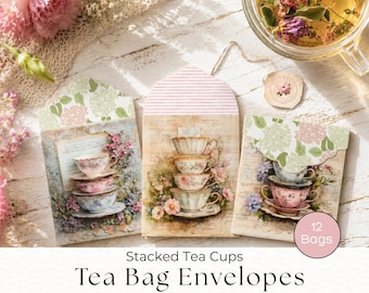 May include: Three rectangular paper tea bag envelopes featuring illustrations of stacked floral teacups. The envelopes have scalloped or striped flaps and vintage-style script backgrounds. A pink circular label reads 12 Bags.