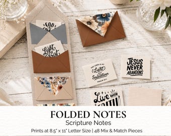 Könnte beinhalten: Ein Set aus gefalteten Schriftstellen-Notizen mit verschiedenen Designs, darunter einfarbige und florale Muster. Mehrere Karten zeigen religiöse Texte wie God is Good, Light of Christ, The Lord is My Light and Salvation Psalm 27:1, Jesus Never Abandons und Live with Faith. Das Set druckt auf 21,6 cm mal 27,9 cm.