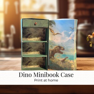 May include: A green Dino Minibook Case with three shelves, open to reveal a dinosaur scene. The right side of the case features a colorful illustration of dinosaurs and a volcano. Text on the bottom reads "Dino Minibook Case" and "Print at home."