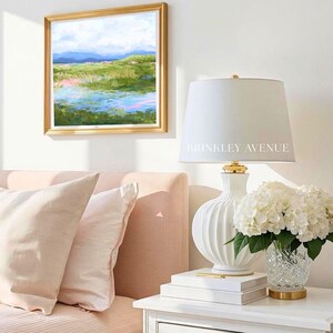 Contemporary low country marsh abstract canvas print featuring southern wetland landscape with soft blue sky, green marsh grasses, reflective water, coastal Grandmillennial home decor wall art in gold frame