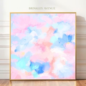 May include: Abstract art print in a gold frame. The artwork features a colorful blend of brushstrokes in shades of pink, blue, and peach. The text "BRINKLEY AVENUE" is at the top of the print.