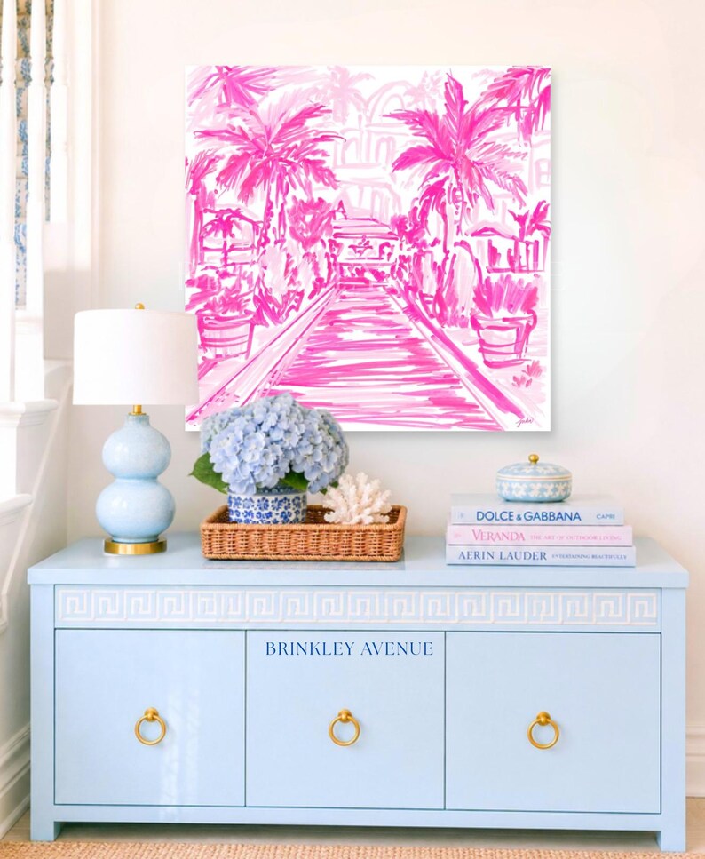 Hand-drawn pink coastal artwork depicting a Palm Beach–style walkway lined with palm trees, tropical foliage, and resort architecture; preppy, vibrant, tropical illustration with a summery coastal aesthetic