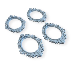 May include: Four light blue, oval-shaped frames with detailed scrollwork and decorative elements. The frames are arranged on a white background, highlighting their intricate design, suitable for crafting or decorative projects.