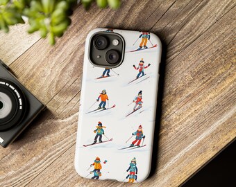 May include: White iPhone case featuring a repeating pattern of skiers in colorful winter attire. The skiers are depicted in various poses, skiing down a snowy slope. The case has a glossy finish and a camera cutout.