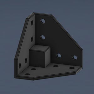 May include: Black metal corner bracket with multiple holes for mounting. The bracket has a square block in the corner.