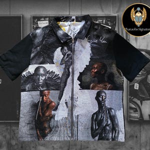 May include: A short-sleeved shirt with a black collar and sleeves, featuring a collage of black and white portraits and figures. The shirt has a full-length zipper and the text "Forgive You" is visible.