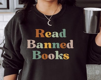 May include: Black sweatshirt with the text "Read Banned Books" in colorful letters. The letters are in a retro style font.