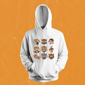 May include: White hooded sweatshirt with a graphic print of multiple tiger faces and a basketball.