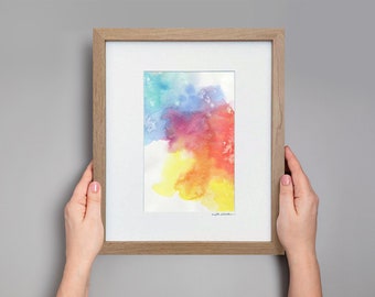 May include: A framed watercolor painting with a colorful abstract design in shades of blue, green, red, orange, and yellow. The painting is in a light brown wooden frame.