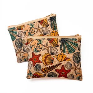 May include: Two rectangular cork zipper pouches with a colorful seashell pattern. The design includes various seashells, starfish, and spiral shells in shades of red, yellow, green, and blue. The pouches have a beige zipper and a natural cork background.