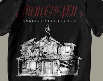 May include: Black t-shirt with a white graphic of a house with broken windows and a bird on the roof. The text "PIERCE THE VEIL" and "COLLIDE WITH THE SKY" is printed in red on the shirt.