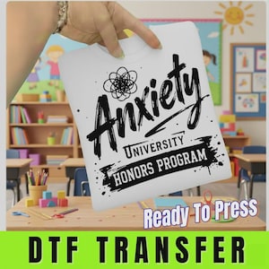 May include: A white DTF transfer sheet featuring black graphic text that reads Anxiety UNIVERSITY HONORS PROGRAM with a scribbled circular icon above the word Anxiety. The design is printed on a smooth, rectangular surface ready for heat application.