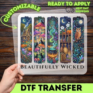 May include: A clear DTF transfer sheet featuring five vertical panels with magical illustrations including a cottage, mushrooms, black cats, a cauldron, potions, brooms, books, and an owl, with the text BEAUTIFULLY WICKED printed below.
