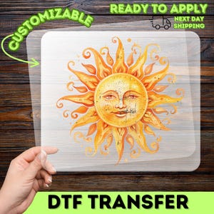 May include: A DTF transfer featuring a watercolor illustration of a smiling sun with orange and yellow rays. The transfer is labeled "Customizable" and "Ready to Apply" with "Next Day Shipping".