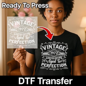 May include: Black t-shirt with a white graphic that reads "VINTAGE 1972 ORIGINAL QUALITY LIMITED EDITION Aged To PERFECTION". The words "Ready To Press" are at the top, and "DTF Transfer" is at the bottom.
