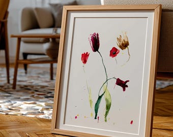 May include: A framed watercolor painting of flowers, featuring red and purple blooms with green stems, rests on a wooden floor. The artwork is in a light wood frame. The room includes a yellow armchair and other artwork.