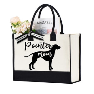 May include: A white canvas tote bag with black trim and handles. The bag has a black silhouette of a pointer dog and the text "Pointer mom" printed on the front.