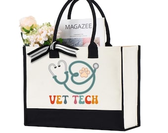May include: A canvas tote bag with black trim and handles. The bag features a stethoscope design with a paw print and the words "VET TECH" in colorful letters. The bag is filled with flowers and a magazine.