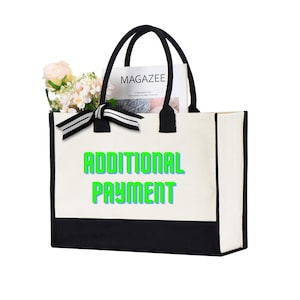 May include: A white canvas tote bag with black trim and black handles. The bag has a black and white striped ribbon tied around the handles. The bag has the text "ADDITIONAL PAYMENT" printed on the front in green letters with a blue outline.