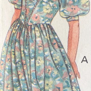 May include: A vintage-style sewing pattern illustration labeled A, featuring a dress with a teal floral print, puff sleeves, a square neckline, and a gathered skirt. The figure wears a matching teal hair bow and has wavy brown hair.