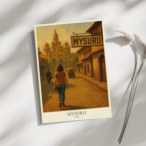 May include: A vintage-style travel poster featuring a street scene in Mysuru, India. The artwork depicts a woman walking down a road, with a sign that reads "MYSURU" and a large building in the background. The poster has a warm, sepia-toned color palette.