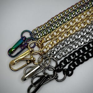 May include: Five different chain styles with lobster clasps. The chains are black, silver, gold, and iridescent.