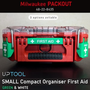May include: A small red Milwaukee PACKOUT 48-22-8435 compact organiser first aid box with green "FIRST AID" labels. The box has a clear lid and a black handle.