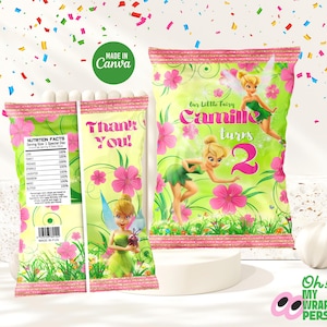 Peut inclure: Sacs de cadeaux de fête sur le thème de Clochette. Les sacs sont vert clair avec des accents floraux roses et le texte "Merci !" et "Camille a 2 ans". Les sacs comprennent également des informations nutritionnelles et les mots "Made in Canva".