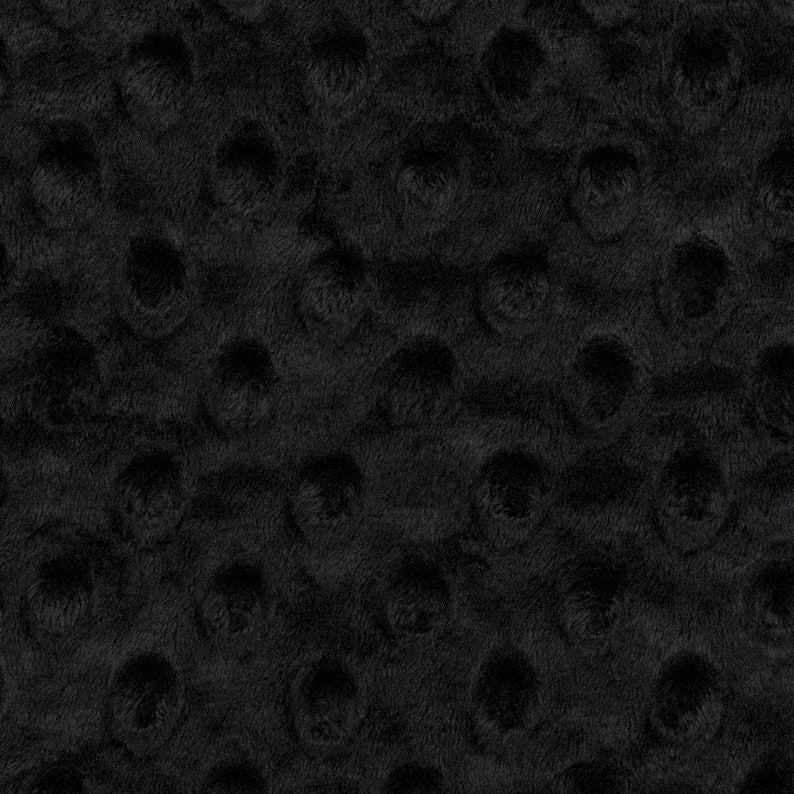 May include: Black fabric with a textured pattern of small raised circles.