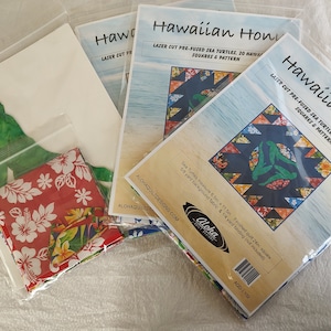 May include: Three packages of pre-fused fabric squares for quilting. Each package contains 20 squares and a pattern for a Hawaiian Honu quilt. The quilt features sea turtles and Hawaiian print fabric. The finished quilt measures 26 inches square.