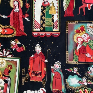 May include: A black fabric with a colorful Christmas nativity scene pattern. The pattern includes figures of Mary, Joseph, baby Jesus, angels, shepherds, and a star. The fabric is decorated with gold stars and other details.