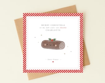May include: A square greeting card with a red and white diagonal striped border. The center features a cartoon chocolate yule log with a face, holly, and stars. Text reads: MERRY CHRISTMAS to my fab-yule-ous Bestie CHARLOTTE - love Grace.