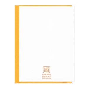 May include: Blank greeting card with a yellow border and a small, orange rectangle in the bottom right corner with the text "CATS LOCK" in white, "BLANK INSIDE" in black, "PRINTED IN NJ" in black, and "CATSLOCK.COM" in black.
