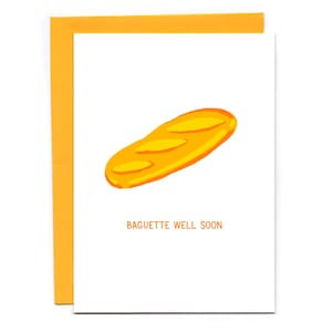 May include: A white card with a yellow baguette illustration and the text "Baguette Well Soon".