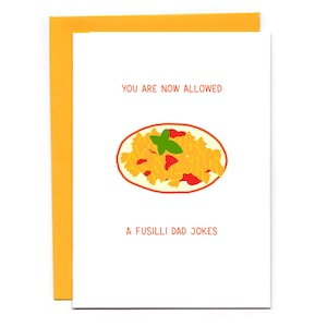 May include: A white card with a yellow border. The card has a cartoon illustration of a plate of fusilli pasta with tomato sauce and a green basil leaf. The text on the card reads "You are now allowed a fusilli dad jokes".