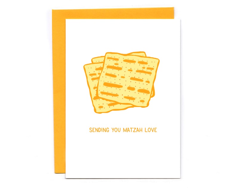 May include: A white card with a yellow border and a drawing of matzah on it. The text "Sending you matzah love" is printed on the card.