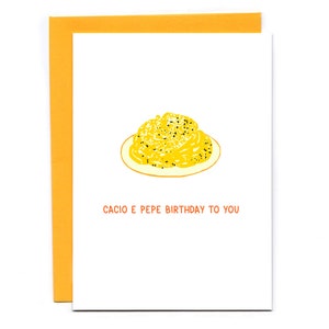 May include: A white card with a yellow illustration of a plate of pasta with the text "Cacio e Pepe Birthday to You" in orange.