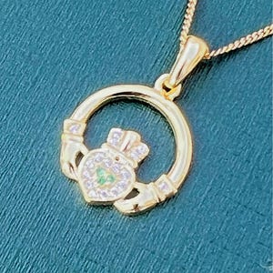 Green and whits stone 14 ct coated on Sterling silver Claggagh pendant on an 18 inch chain .