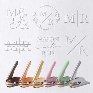 May include: A selection of personalised embossing seals in shades of brown, rose gold, gold, pink, green, and silver. The image displays embossed designs with the text "MR" and "Mason and Red".