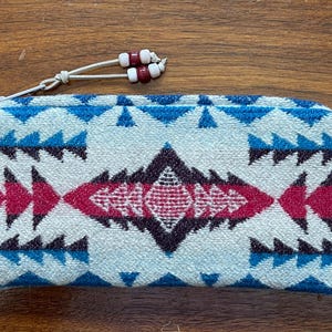 May include: A handmade wooden sign with the text "Welcome to our home" in a handwritten style. The sign is painted white with a dark stained frame. A small, decorative heart is in the bottom right corner.