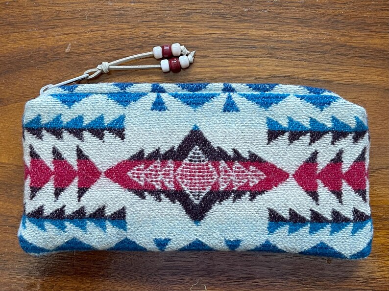 May include: A handmade wooden sign with the text "Welcome to our home" in a handwritten style. The sign is painted white with a dark stained frame. A small, decorative heart is in the bottom right corner.