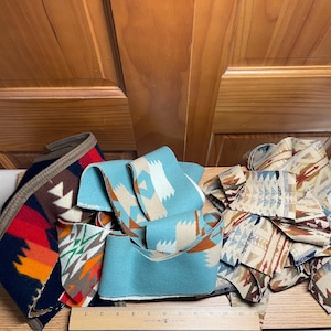 May include: Three fabric strips with geometric patterns are displayed above a wooden ruler measuring 30 cm. The left strip is navy, red, and orange; the centre is light blue and tan; the right strip is cream, brown, and blue.
