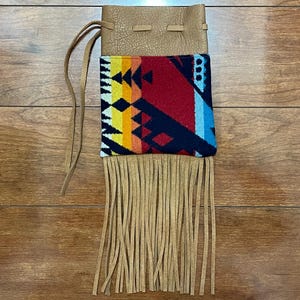 May include: A set of three ceramic mugs with a speckled, matte finish. The mugs are in shades of cream, light brown, and dark brown. Each mug has a simple, minimalist design, perfect for coffee or tea.